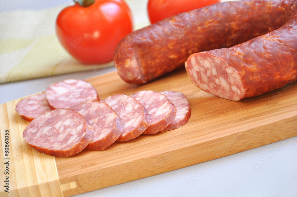 Mouth-watering smoked sausage and ripe tomatoes Mouth-watering smoked sausage and ripe tomatoes
