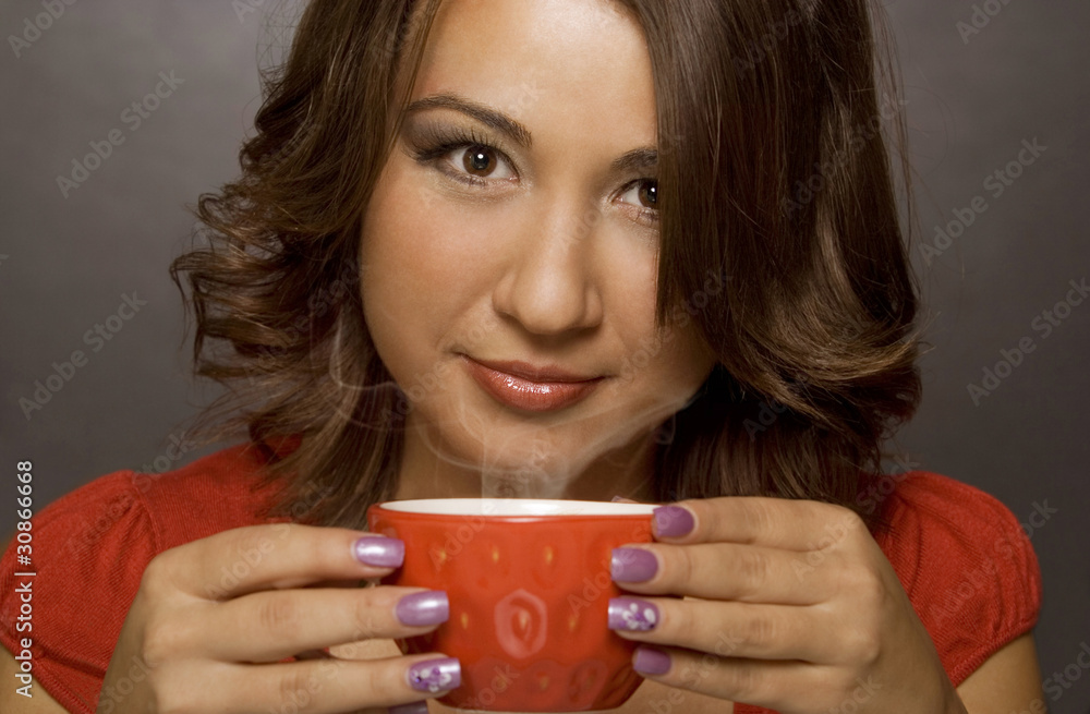 Young girl drinking a cup of hot tea Young girl drinking a cup of hot tea