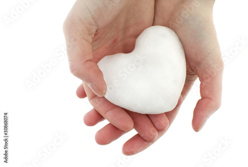 lump of snow in the shape of a heart in hands