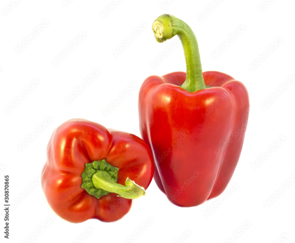 Two fresh red peppers on white background