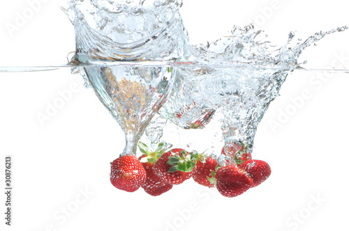 Strawberry falling in water