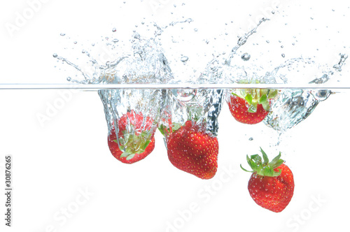 Strawberry falling in water