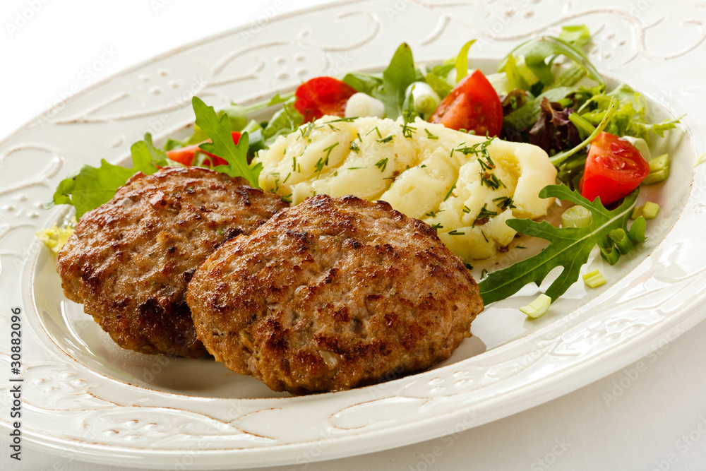 Fried steaks with mashed potatoes and vegetable salad Fried steaks with mashed potatoes and vegetable salad