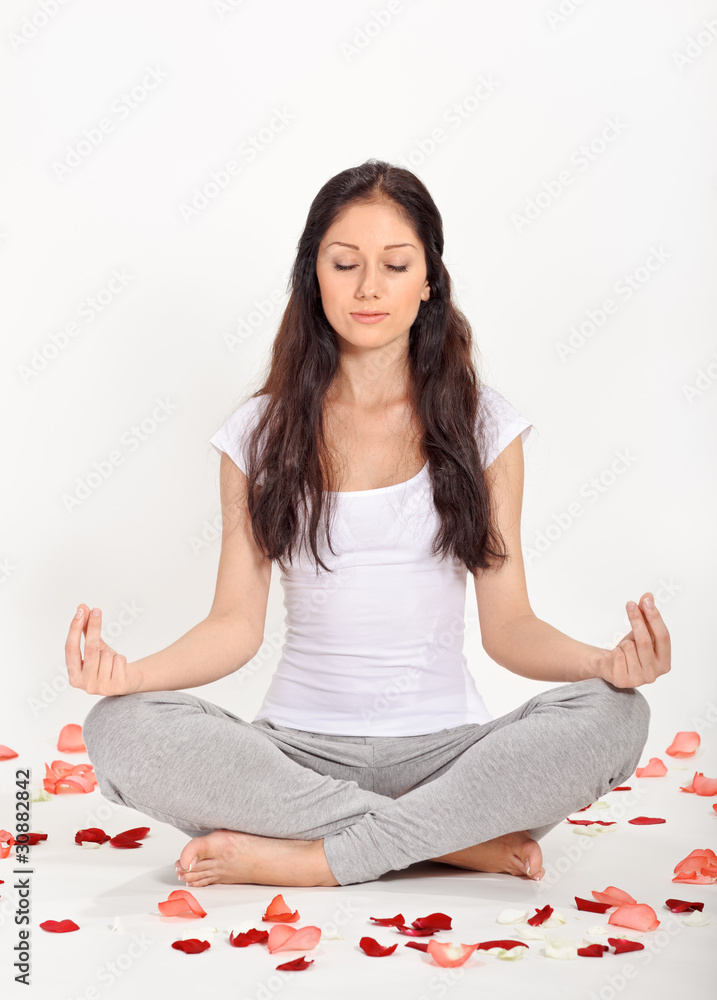 Young beautiful woman meditating in lotus pose Young beautiful woman meditating in lotus pose