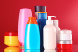 bottles of health and beauty products on red background