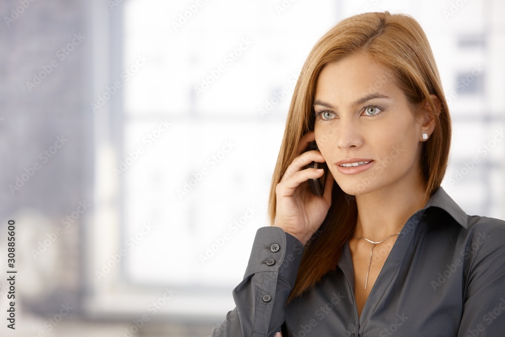 Portrait of businesswoman on call