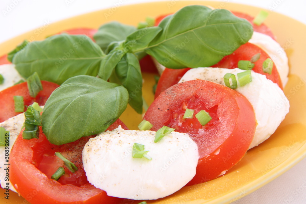 Caprese salad - tomatoes, mozzarella with basil and parsley