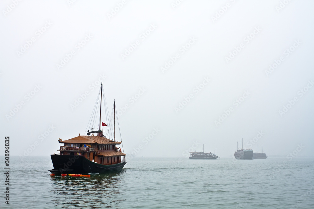 Boats heading off to work in a cloudy day