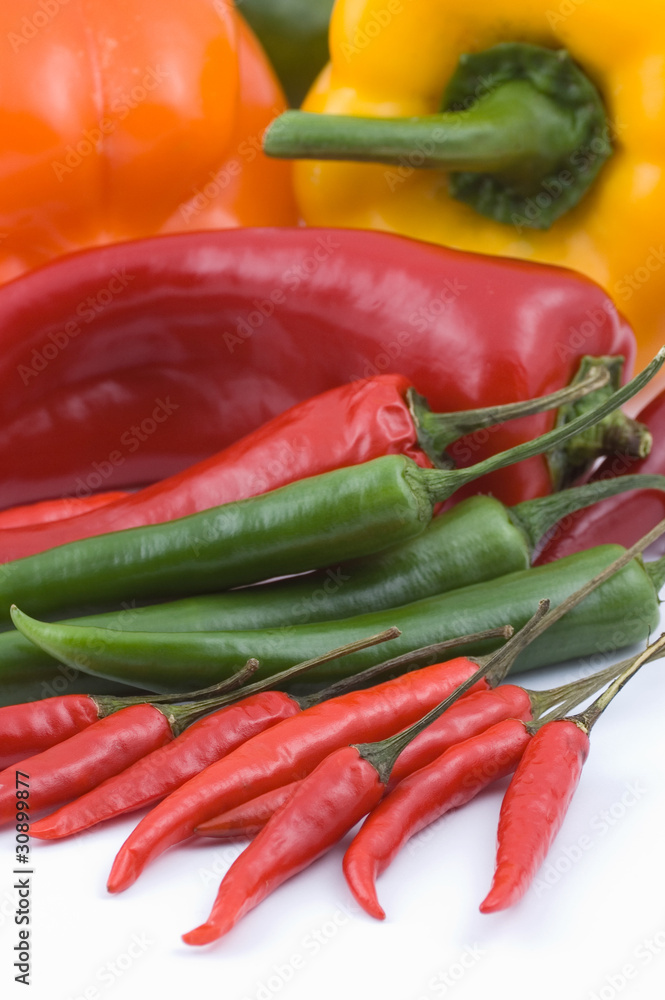 Multicolored peppers on white