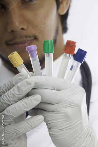 Valokuva medical doctor with evacuated tubes for blood test.