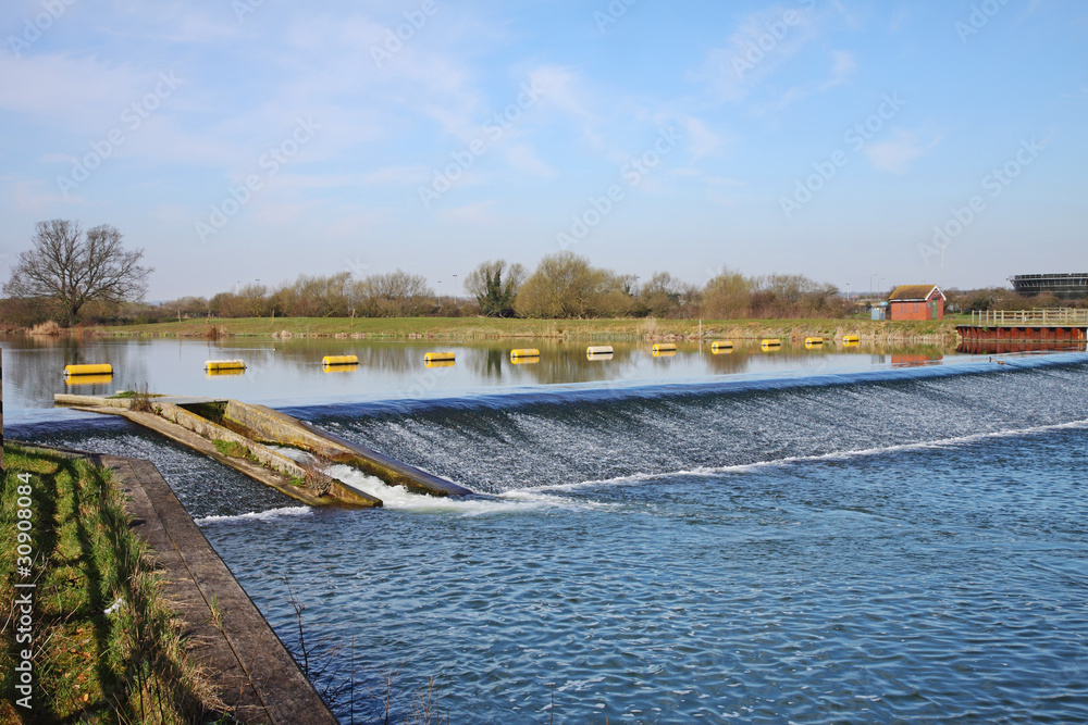 Naklejka premium Floating Barrier on a tranquil blue River
