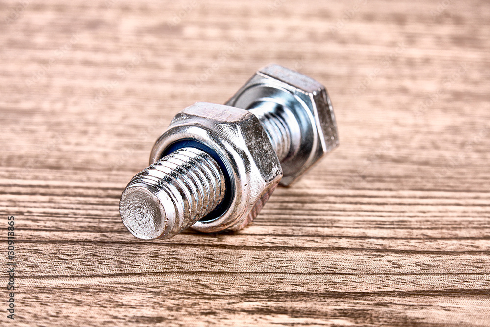 Bolt and screw on wooden table Bolt and screw on wooden table