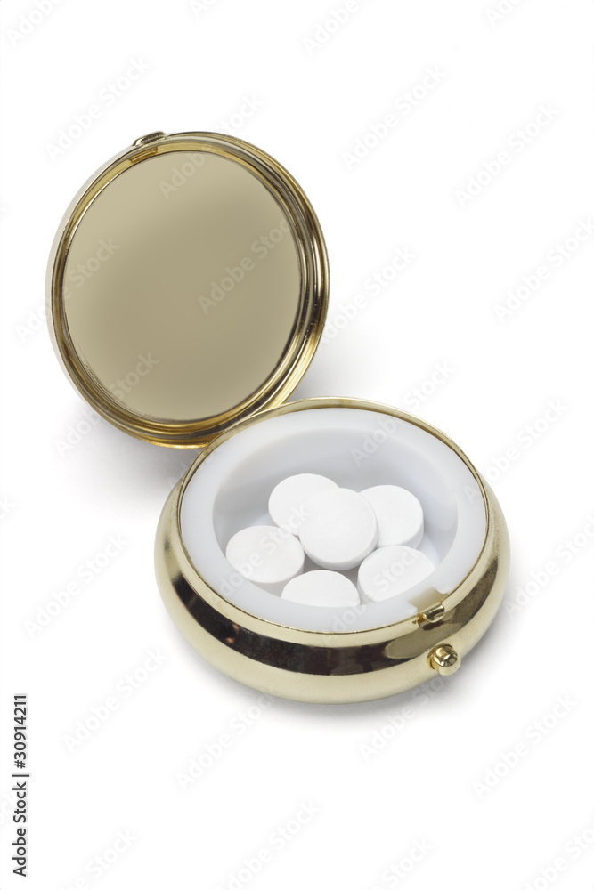 Medicine in round metal pill container Medicine in round metal pill container