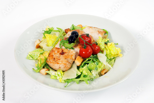 Caesar salad with chicken steak on white background