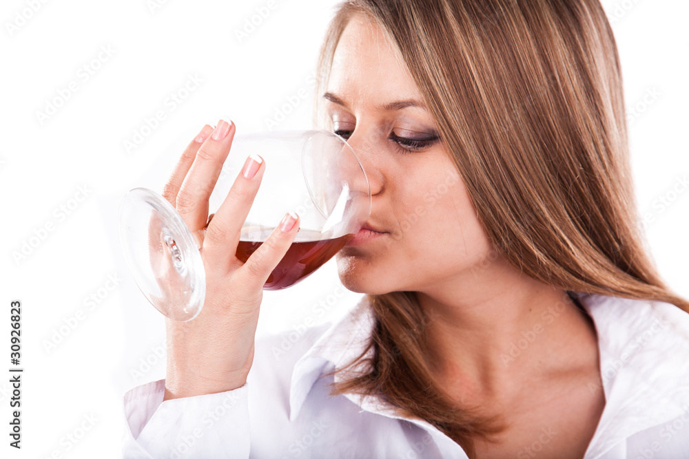 Beautiful woman drinking cognac from a snifter Beautiful woman drinking cognac from a snifter
