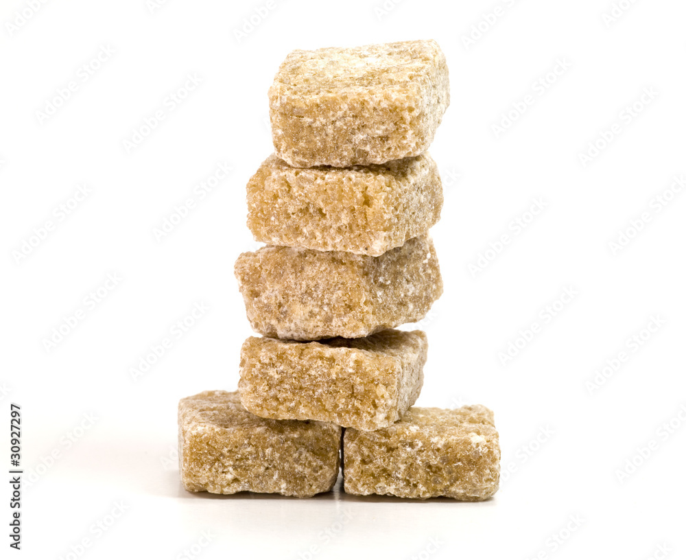 Tower of brown sugar cubes on white background Tower of brown sugar cubes on white background