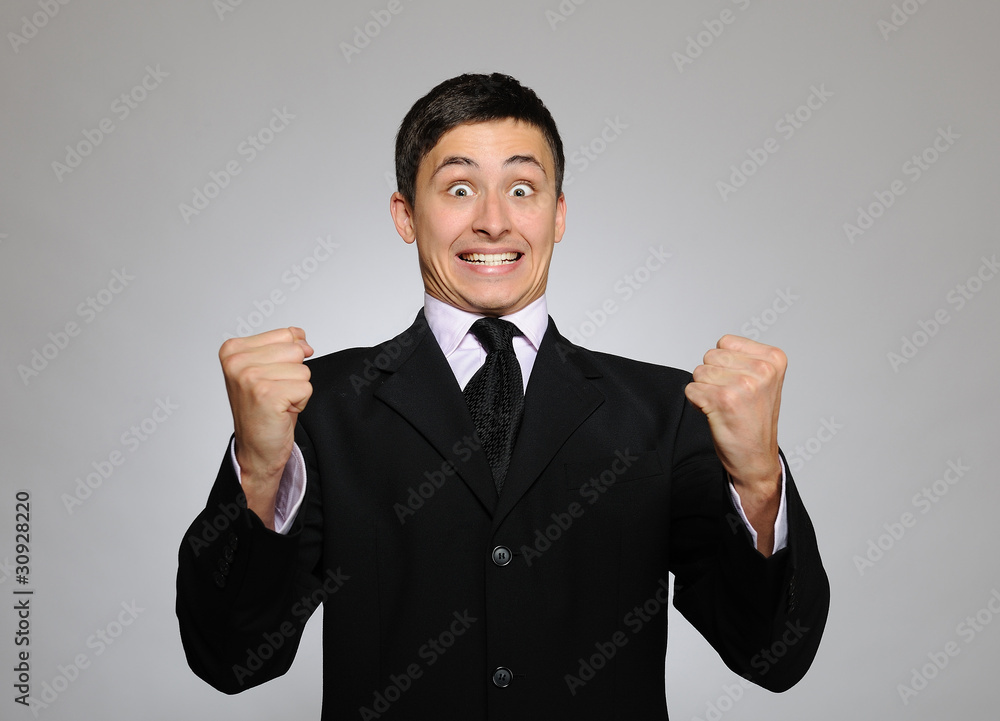 Expressions - Young handsome business man screaming of joy and l Expressions - Young handsome business man screaming of joy and l