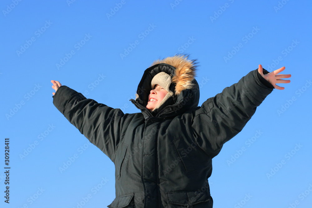 happy boy in the winter on the blue sky background happy boy in the winter on the blue sky background