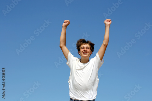 happy teenager running on blue sky background