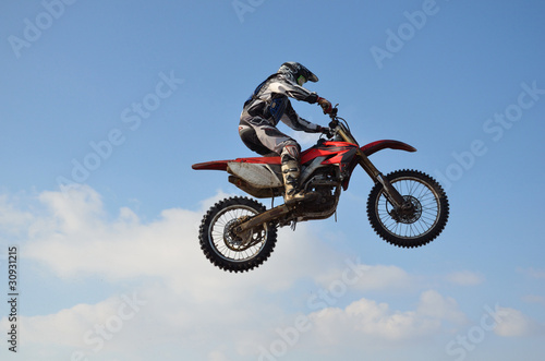 motocross rider jump  blue sky