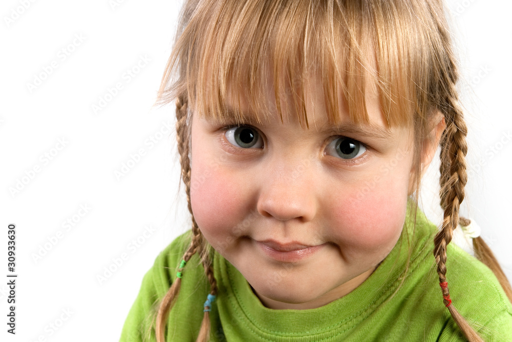 Face a little girl with pigtails closeup Face a little girl with pigtails closeup