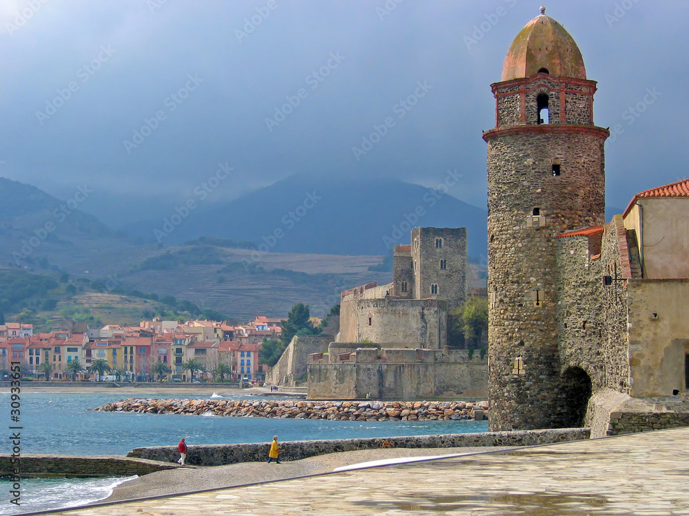 Bell tower and castle in the Mediterranean village of Collioure with stormy sky, Vermilion coast, Roussillon, Pyrenees-Orientales, France