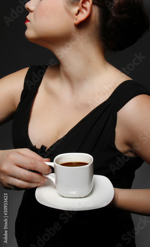 woman holding a cup of coffee on a plate