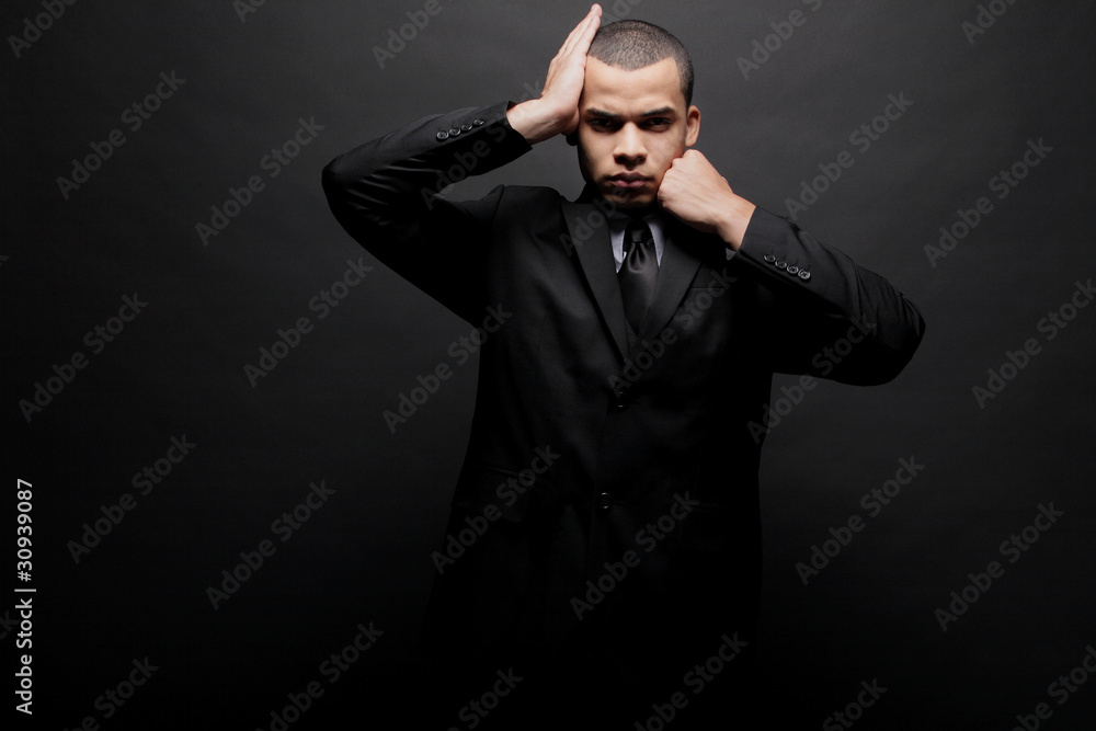 Obraz premium Young businessman in a black suit.
