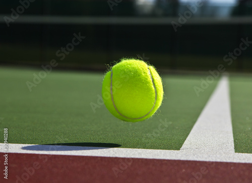 Tennis ball landing just inside outdoor court  © tab62