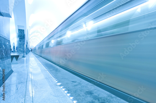 modern illuminated metro station with train motion