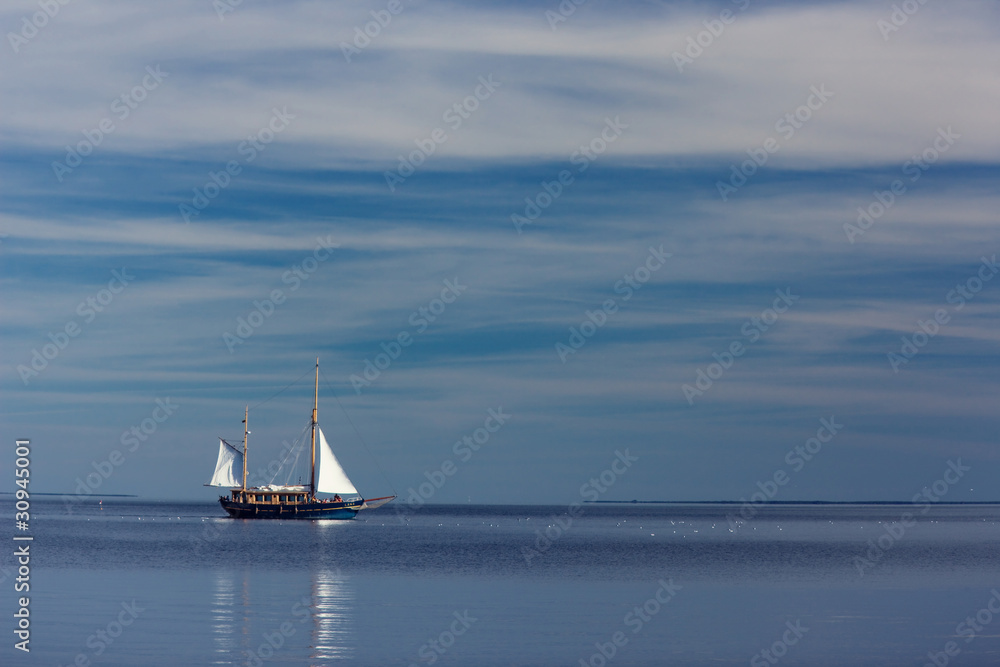 Fototapeta premium Lonely sailboat at sea
