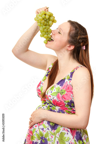 pregnant girl eating grapes.