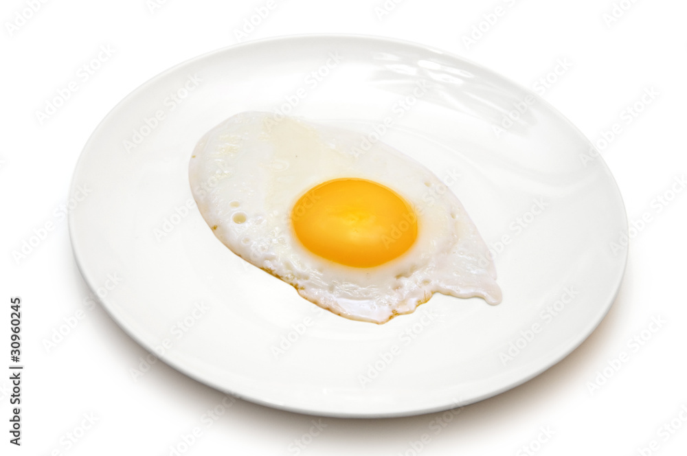 one sunny side up egg on white plate isolated one sunny side up egg on white plate isolated