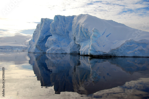 jagged iceberg reflected in the sea