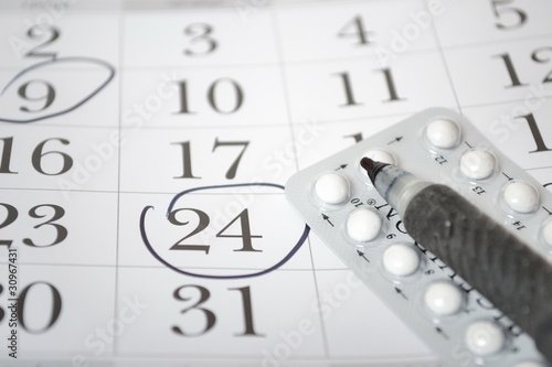 Birth control pills and pen closeup
