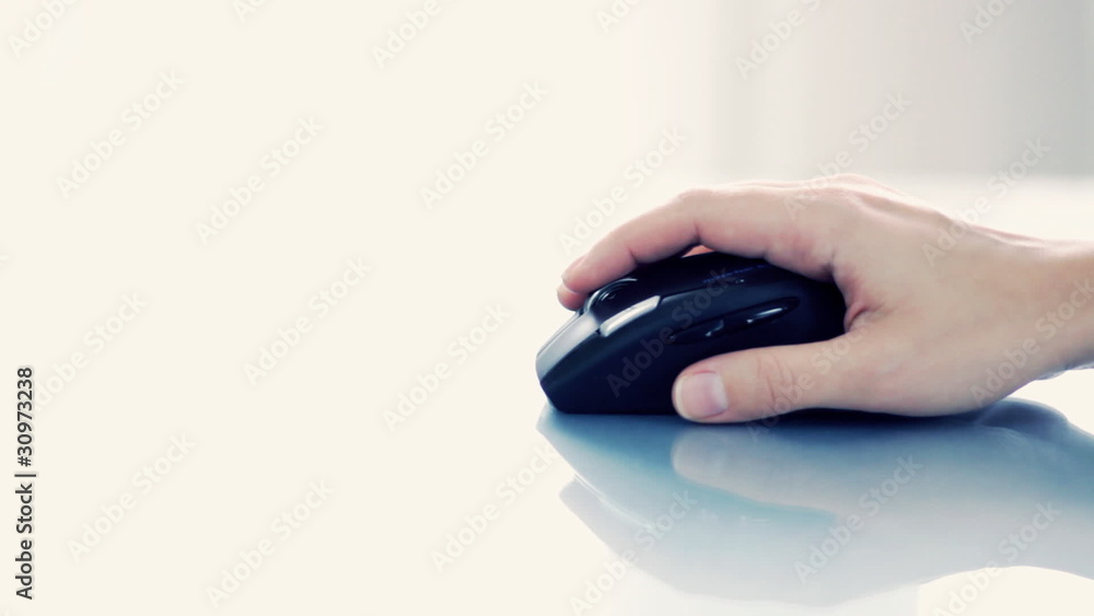 Hand of a woman using a wireless computer mouse Hand of a woman using a wireless computer mouse