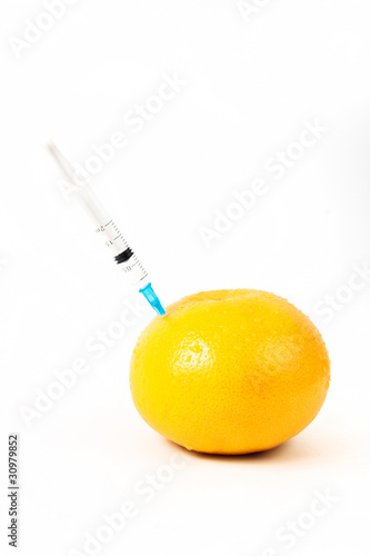 grapefruits with syringe isolated in white