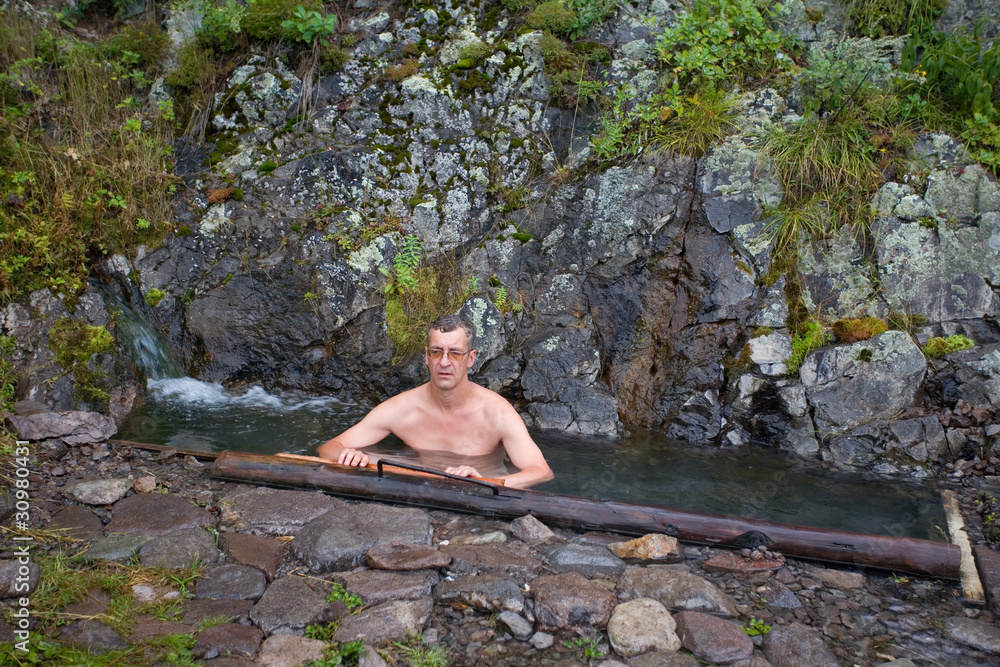 Man adopts the procedures in source with curative water Man adopts the procedures in source with curative water