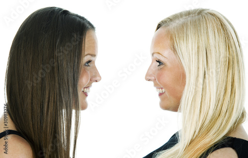 Close-up portrait of two girls isloated on white background -