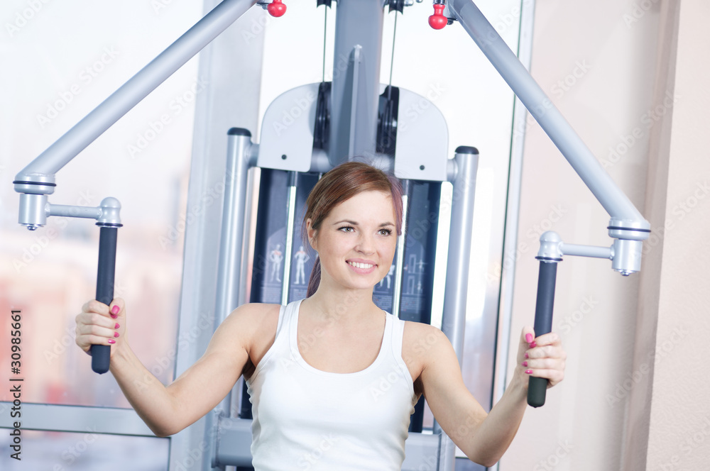 Fototapeta premium Young woman at the gym