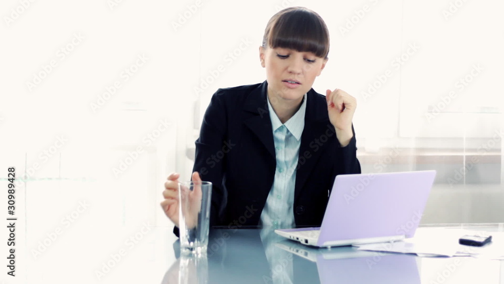 Young attractive businesswoman drinking glass of water Young attractive businesswoman drinking glass of water