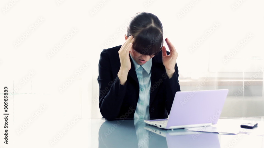 Young attractive businesswoman having headache in the office Young attractive businesswoman having headache in the office