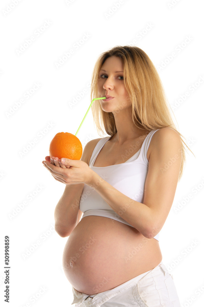 pregnant woman drinking juice from the orange pregnant woman drinking juice from the orange