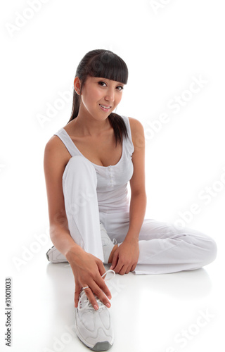 Beautiful smiling healthy woman sitting on the floor