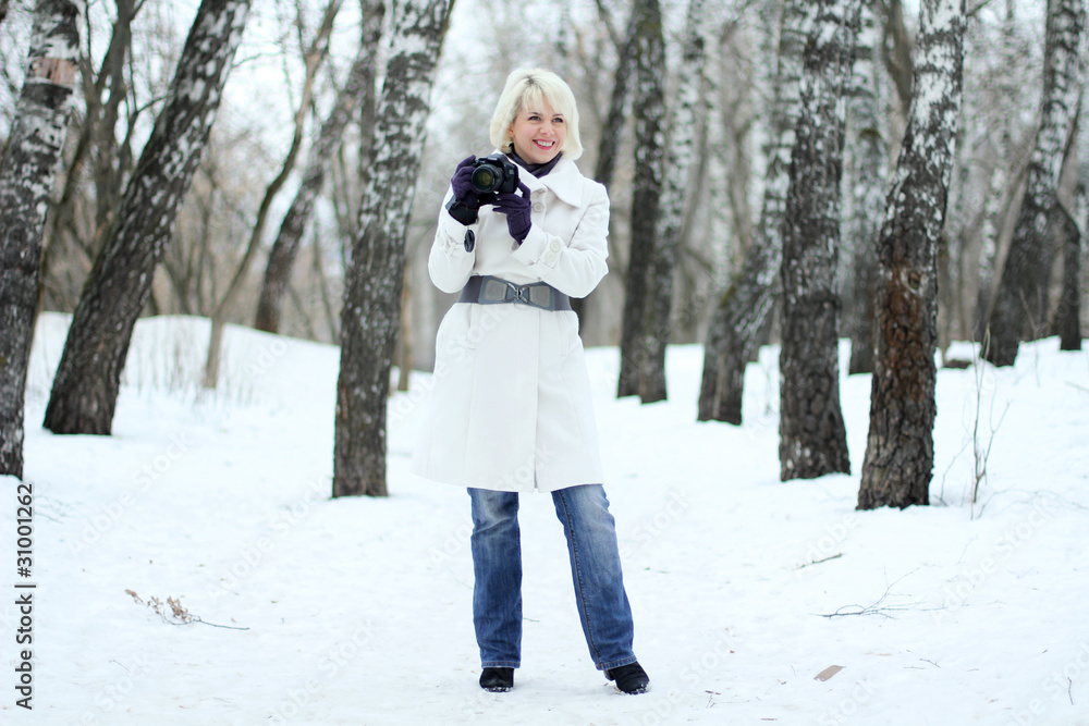 Young woman photographer on winter background Young woman photographer on winter background