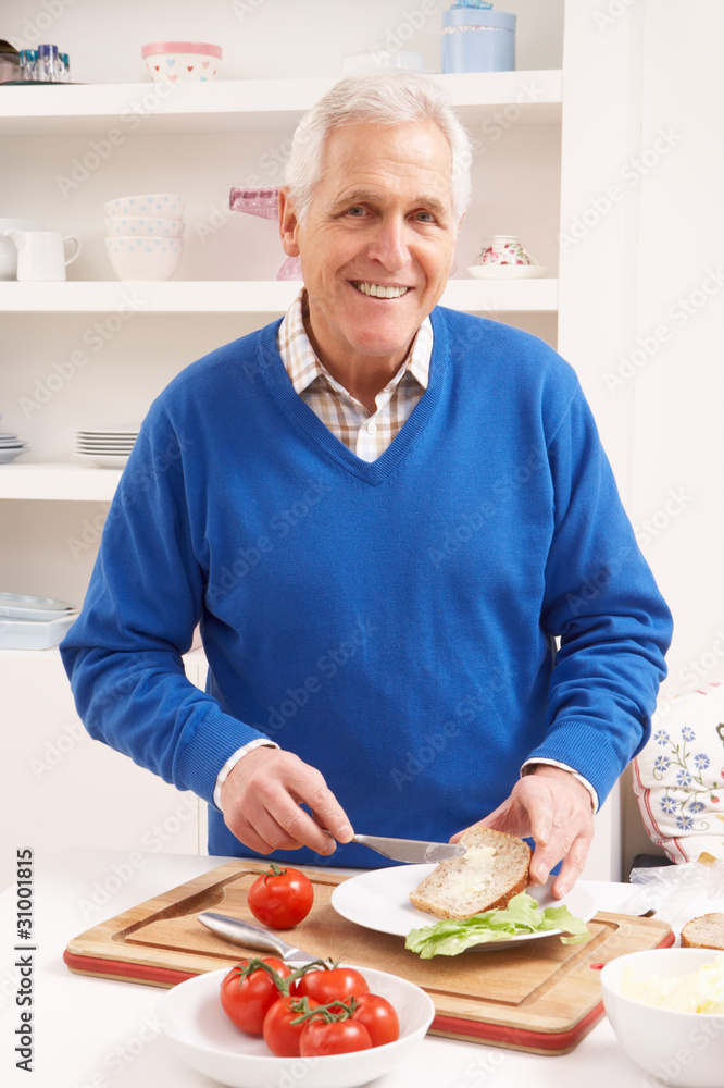 Senior Man Making Sandwich In Kitchen Senior Man Making Sandwich In Kitchen