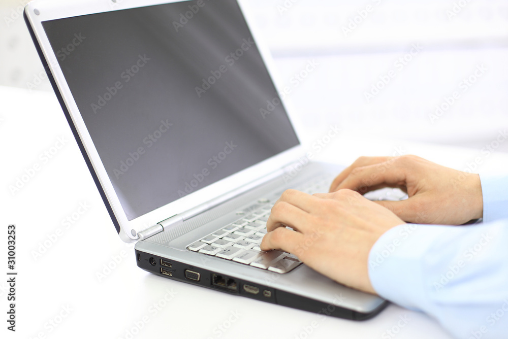 Person Typing on a modern laptop in an office Person Typing on a modern laptop in an office