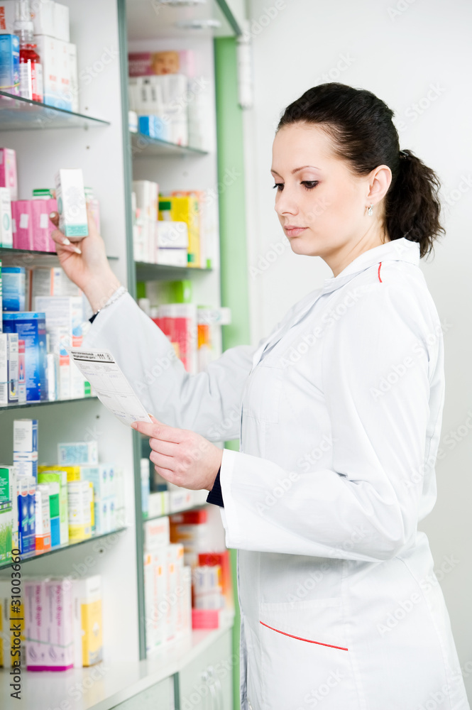 Pharmacy chemist woman in drugstore