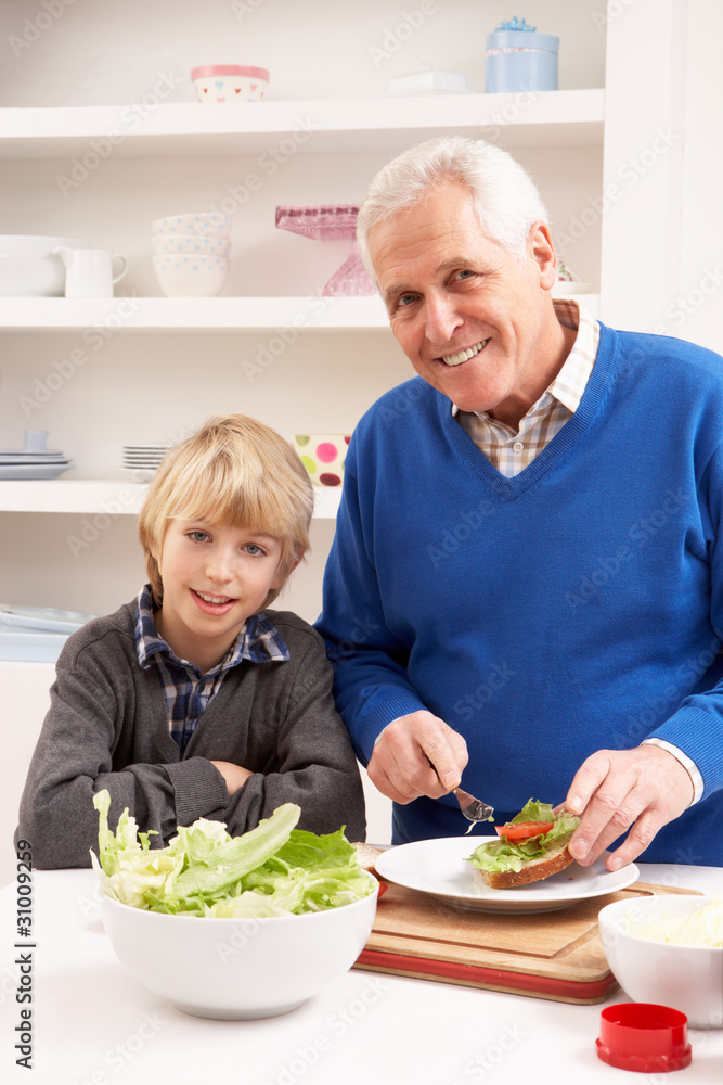 Grandfather And Grandson Making Sandwich In Kitchen Grandfather And Grandson Making Sandwich In Kitchen