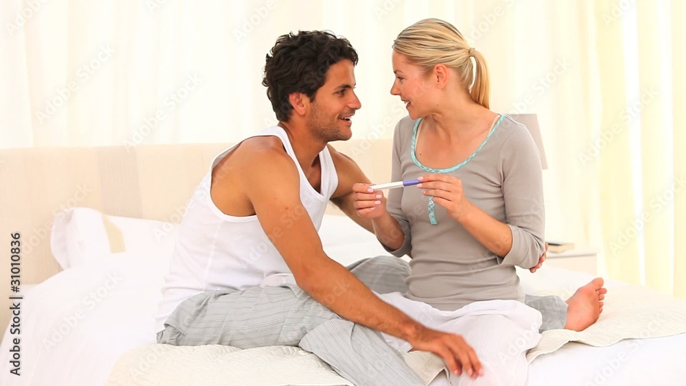 Young couple with a positive pregnancy test Young couple with a positive pregnancy test